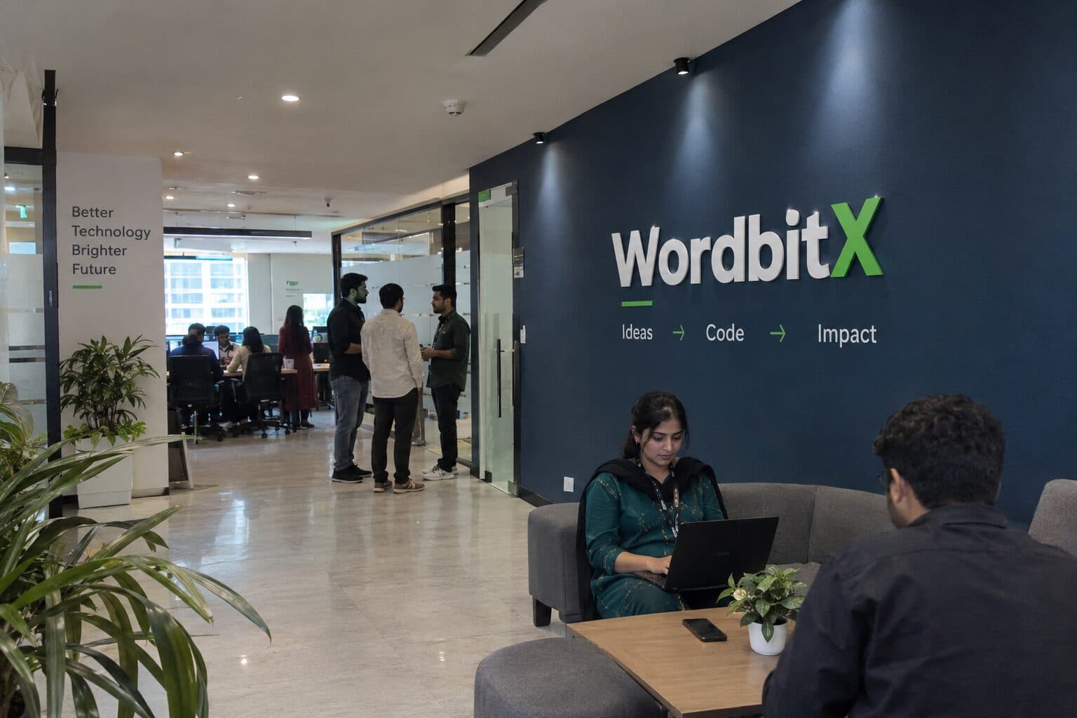 WordbitX studio, Lahore — team collaborating by the brand wall